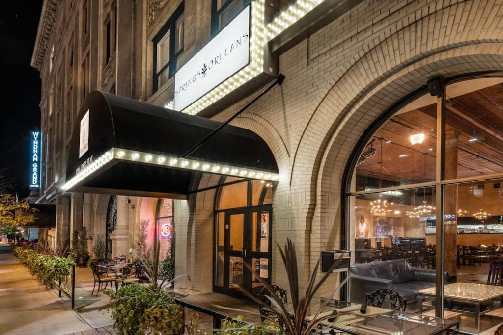 The grand entrance to the The Mining Exchange, A Wyndham Grand Hotel lit up at night, one of the best hotels in Colorado Springs for families.