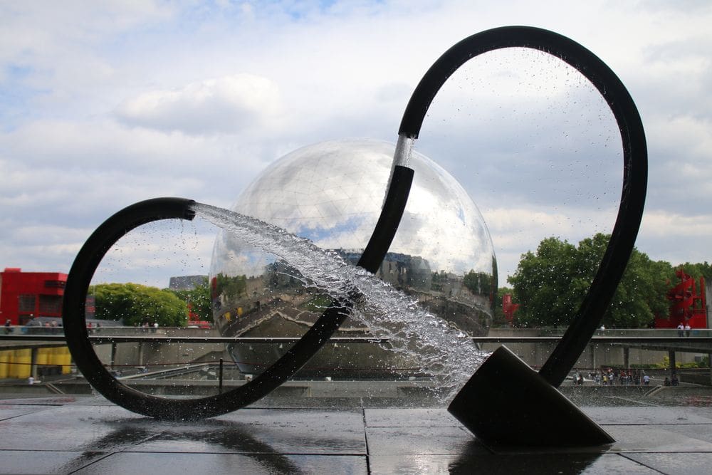 A large art installation within the Parc de la Villette on a sunny day.