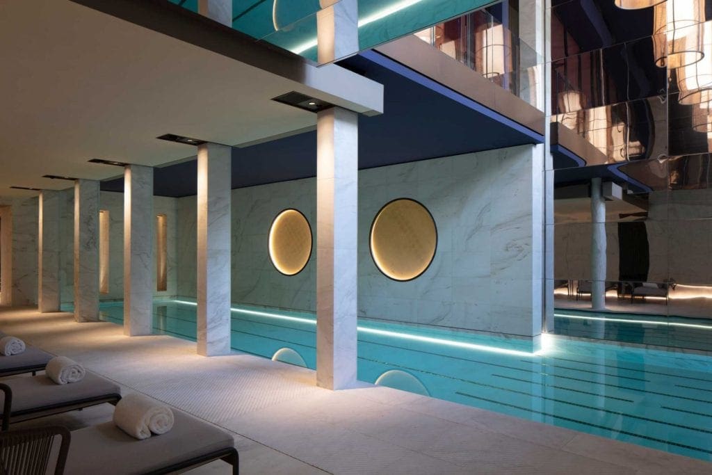 The indoor pool, with poolside loungers, at the Hôtel Lutetia.