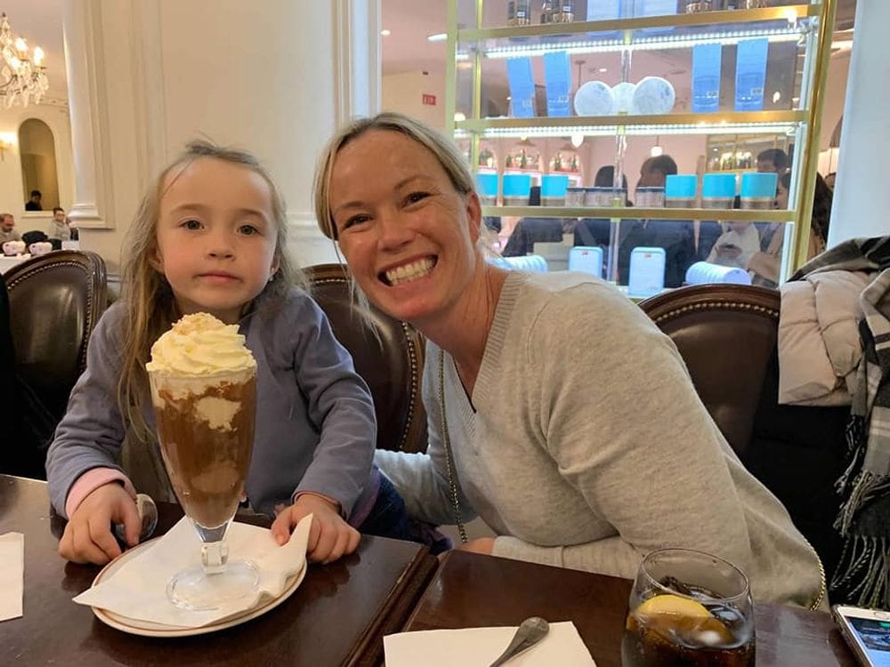 A mom and her daughter indulge in a large chocolate confection at Laduree, one of the best things to do in Paris with young kids.