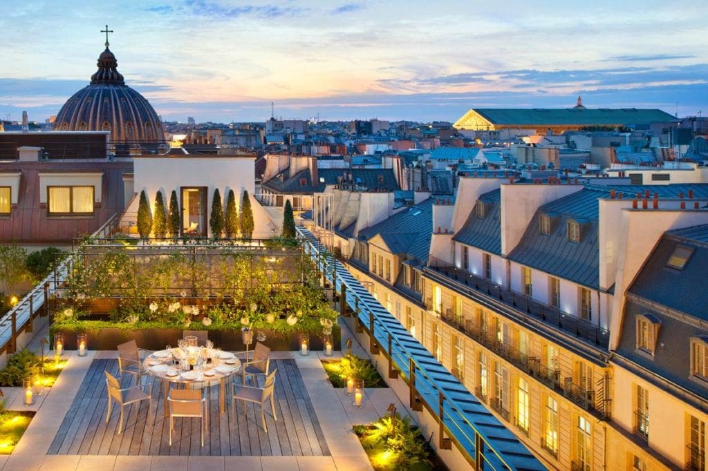 The lit-up courtyard of the Mandarin Oriental, Paris at night, one of the best Paris hotels for families.