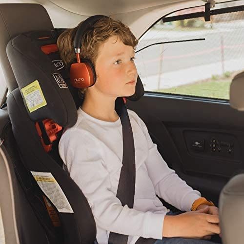 A young boy riding in a carseat features the red Puro Sound Labs PuroQuiets, which are a great way to keep kids entertained while traveling.