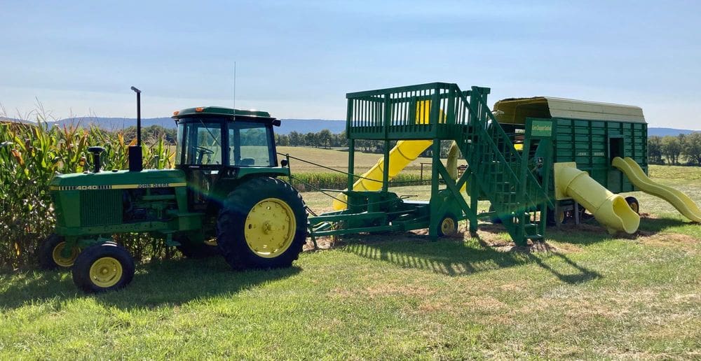 A large play-set resembling tractor pulling a combine waits for children to play on it at Wayside Farm Fun.