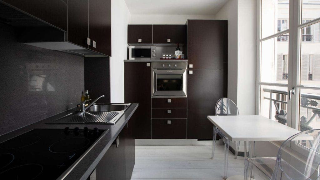 A kitchenette in one of the suites at the Résidence & Spa Le Prince Régent, one of the best Paris hotels for families.