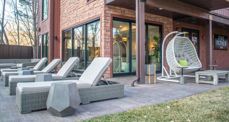 Outside near the pool, featuring comfy pool deck loungers at the Cliffrose Springdale, Curio Collection By Hilton.