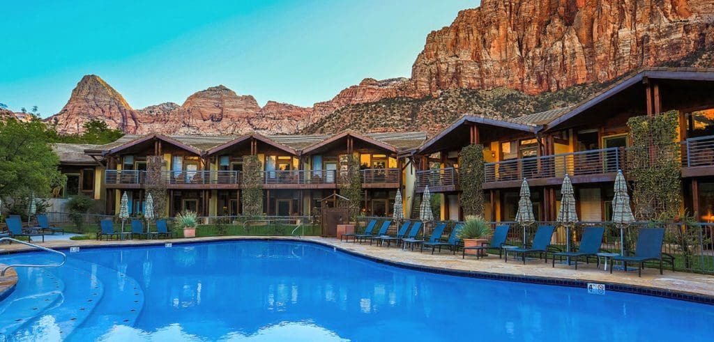 The pool at Desert Pearl Inn, with hotel buildings behind it. This is a great options if you're wondering where to stay near Zion National Park with kids!