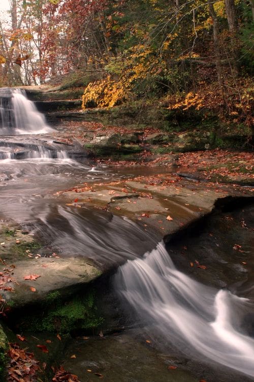 Fall colors encircle Old Man's Cave in Hocking Hills State Park, one of the best places to see fall colors in the Midwest for families.