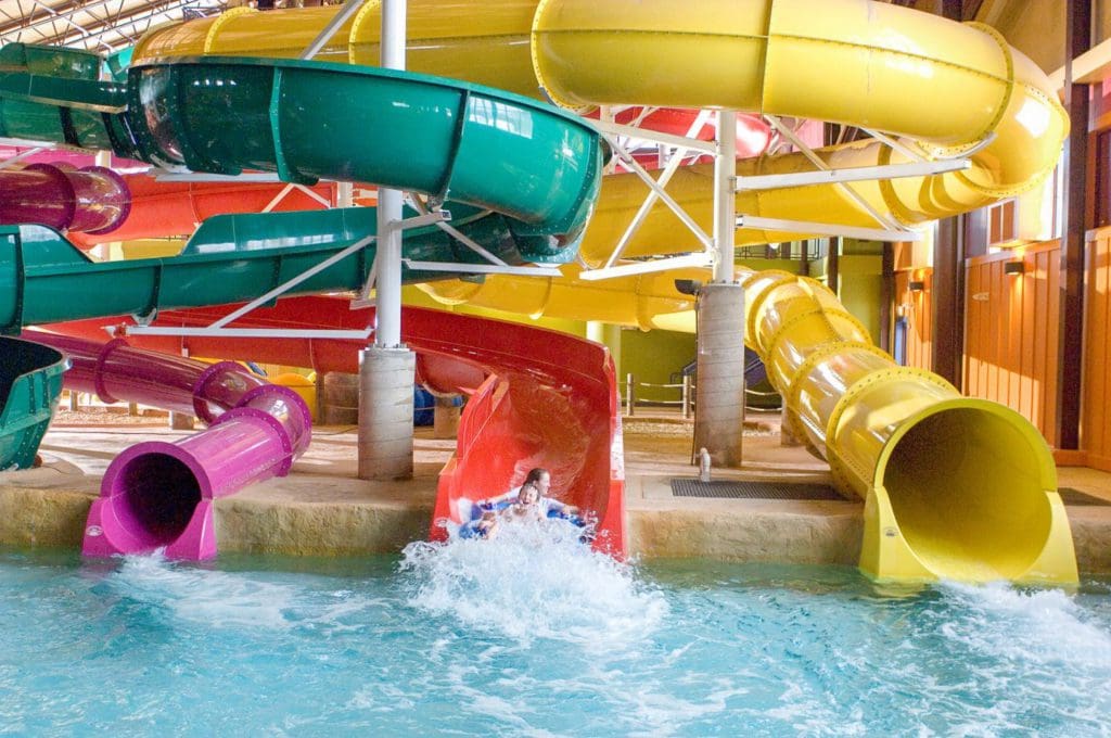 Three colorful slides exit onto a large pool at the Kahuna Laguna at Red Jacket Mountain View.