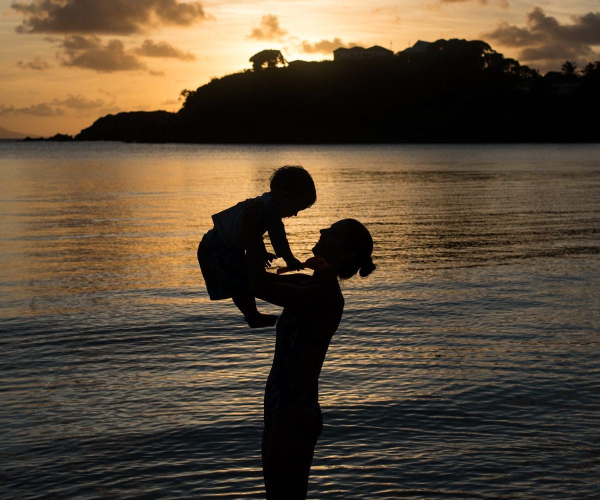 silhouette of mom and son in a beach in Antigua