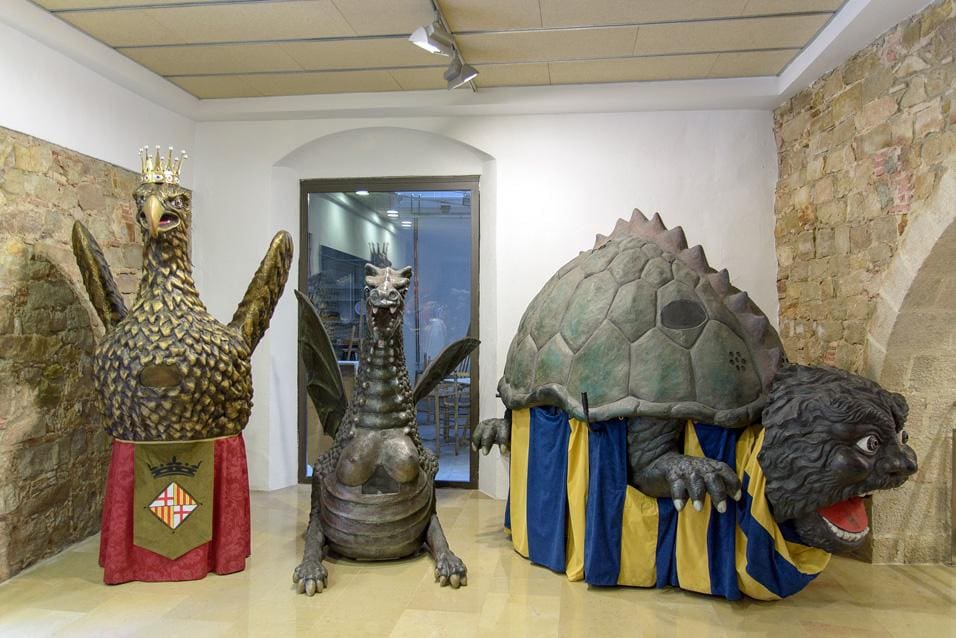 Three large animal-shaped puppets, including one that looks like an eagle and another resembling a turtle.