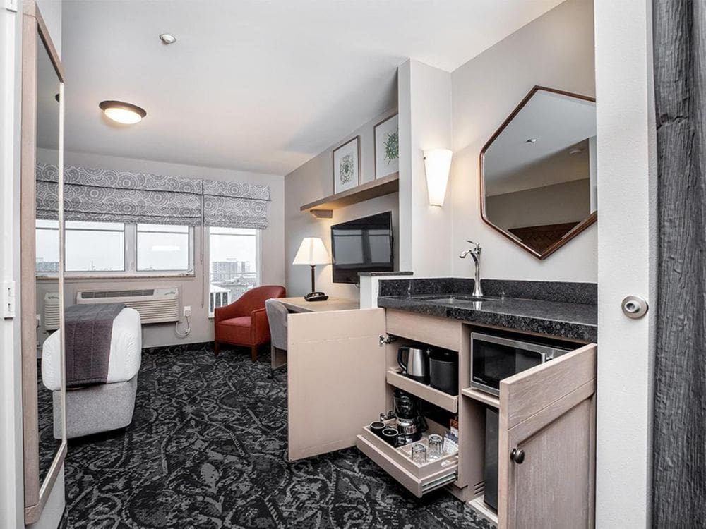 Inside one of the guest rooms at the Mediterranean Inn, highlighting the kitchenette amenities.