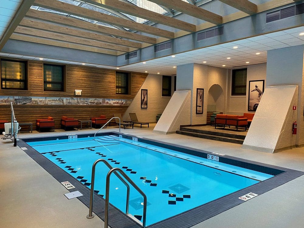 Inside the pool area at the Palmer House, A Hilton Hotel, featuring a large pool deck and seating options.