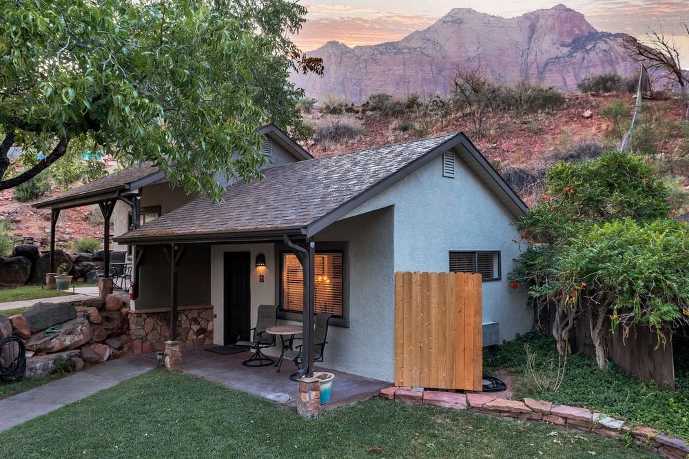 A cozy cabin sits on the edge of the desert mountains near Zion National Park.