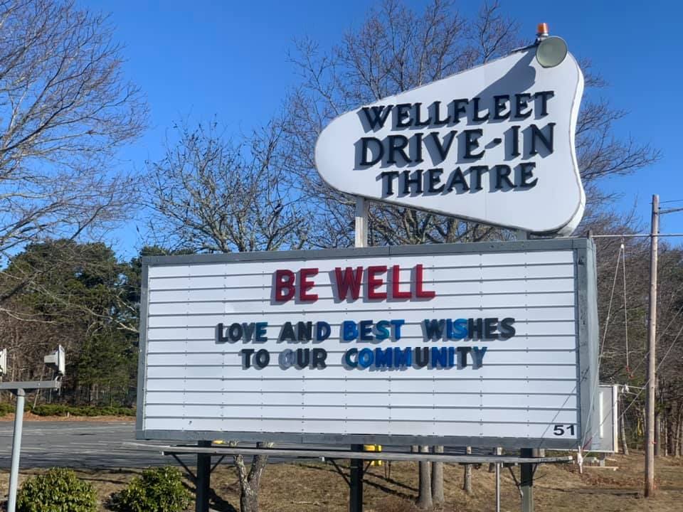 A welcome sign for Wellfleet Drive-In Cinemas, reading "Be Well".