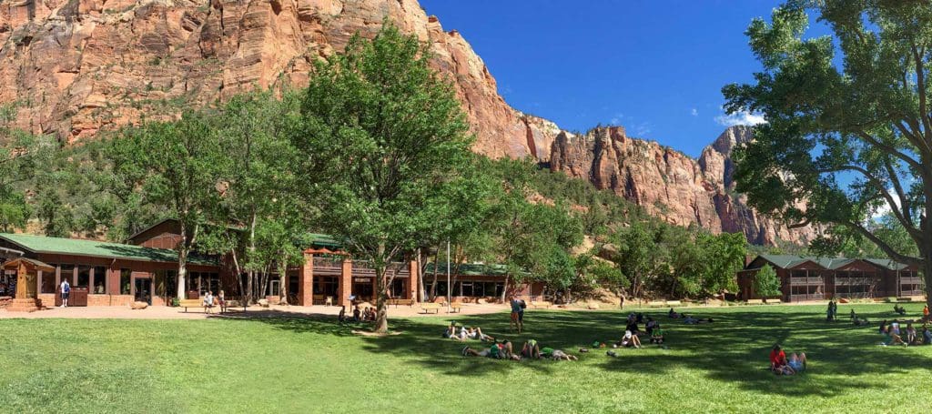 A large field with Zion National Park Lodge in the distance, this is one option for where to stay near Zion National Park with kids!