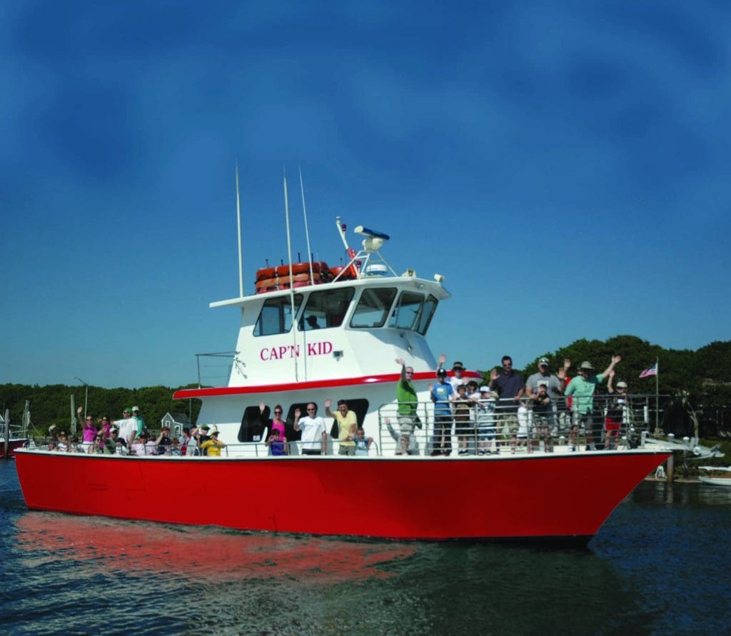 Several guests wave while departing on a tour with Cap’n Kid Fishing Adventures.