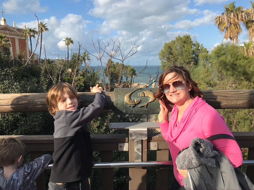 A mother and her two sons enjoys a sunny day in Tel Aviv while touring around, one of the best weekend getaways from Dubai for families.