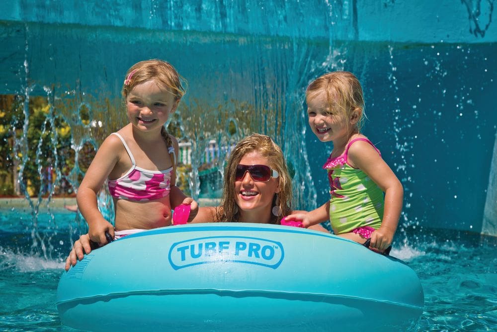 A mom and two of her kids sit in a Tube Pro while enjoying the pool at the Coconut Bay Beach Resort & Spa.