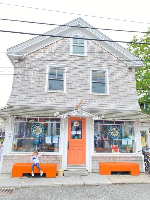 A young girl strikes a pose outside of a cafe in Provincetown.