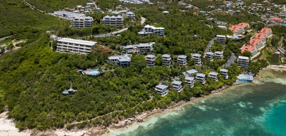 An aerial view of the lush grounds and beach at the Point Pleasant Resort, one of the best US Virgin Islands resorts for families.