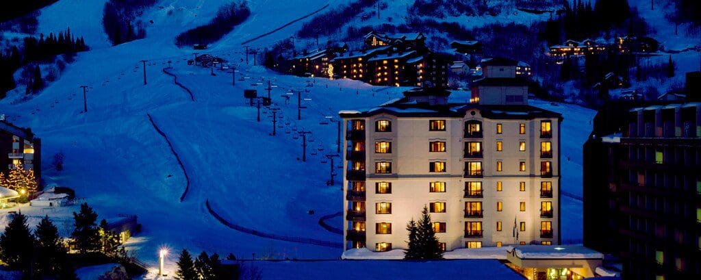 The lit-up resort buildings and ski runs at the Sheraton Steamboat Resort Villas.