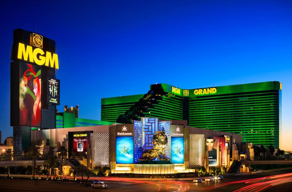 An view of the many exterior buildings for the The Signature at MGM Grand in Las Vegas at night, full of lights.