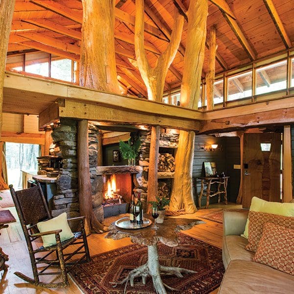 Inside the woodlands suite at Winvian Farm, featuring rustic furnishing, one of the best themed hotels in the United States for families.