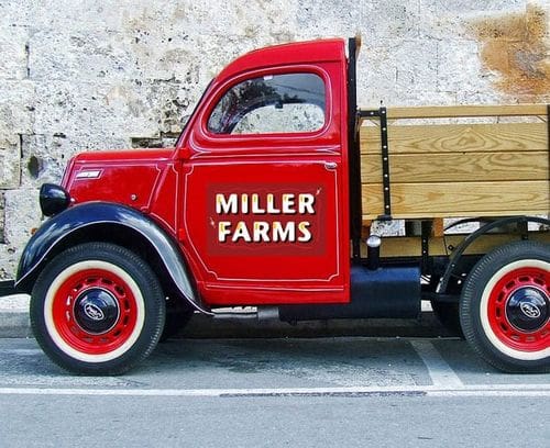 A farm truck with a wooden bed, and a red cab reading "Miller Farms".