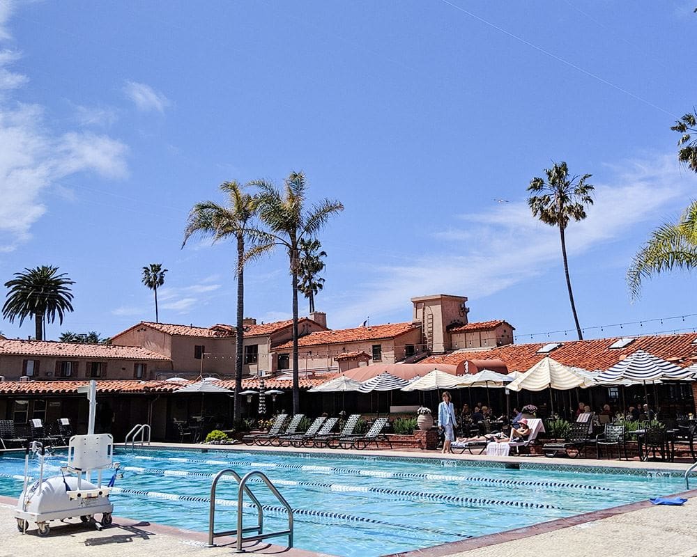 An empty lap pool at the La Jolla Beach and Tennis Club, with resort buildings on the far side.