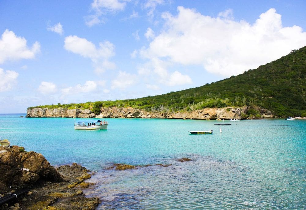 Several people enjoy a tour with Captain Goodlife on a beautiful, clear day in Curacao.