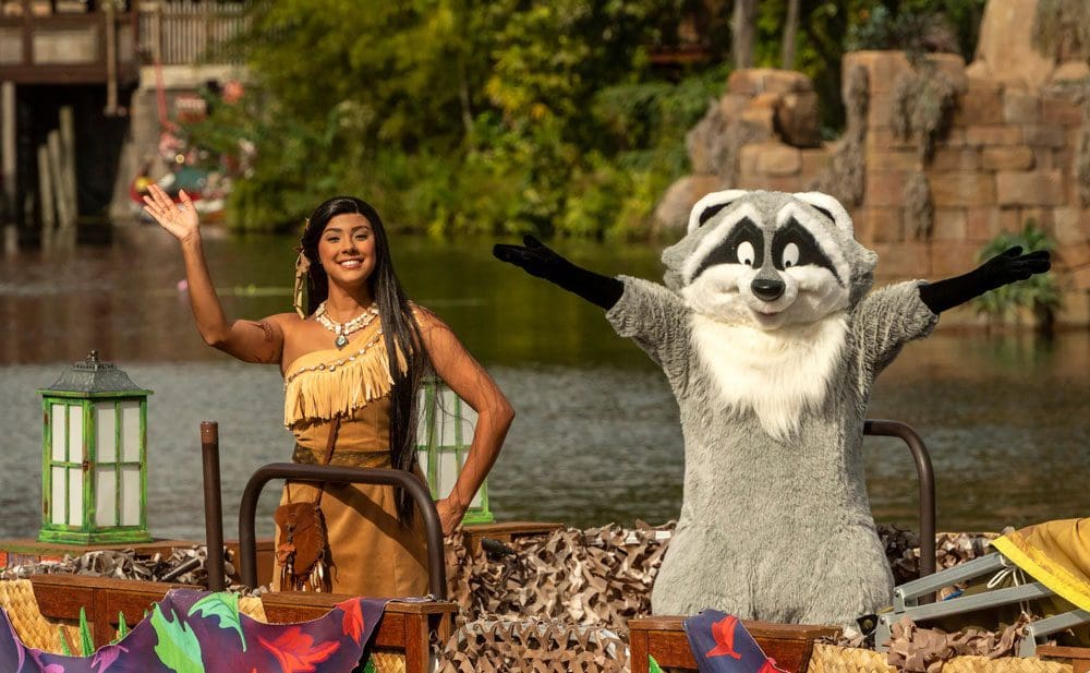 Pocahontas and her raccoon wave from a holiday float at Animal Kingdom, a great event for celebrating the holidays in Disney as a family.