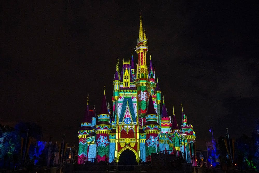 Cinderella's castle at Magic Kingdom lit up for the holiday season, the best place to start when celebrating the holidays in Disney as a family.