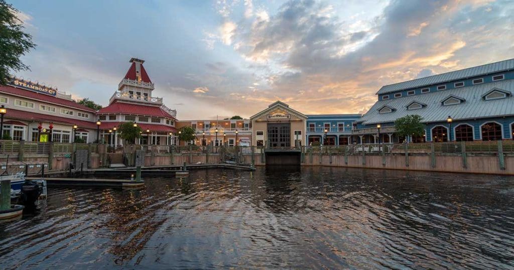 A view of Disney's Port Orleans - Riverside Resort from across the on-site pond at sunset, one of the best Disney moderate resorts for families.
