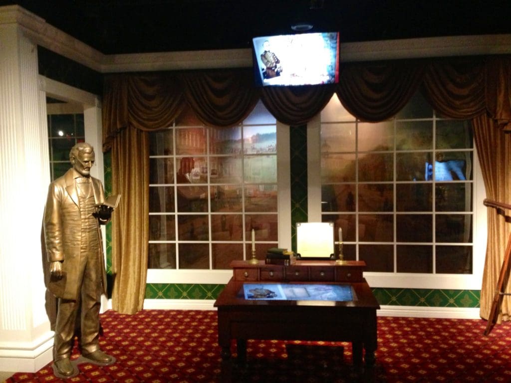 One of the exhibit rooms at the Ford’s Theater National Historic Site, featuring a statue and a desk.