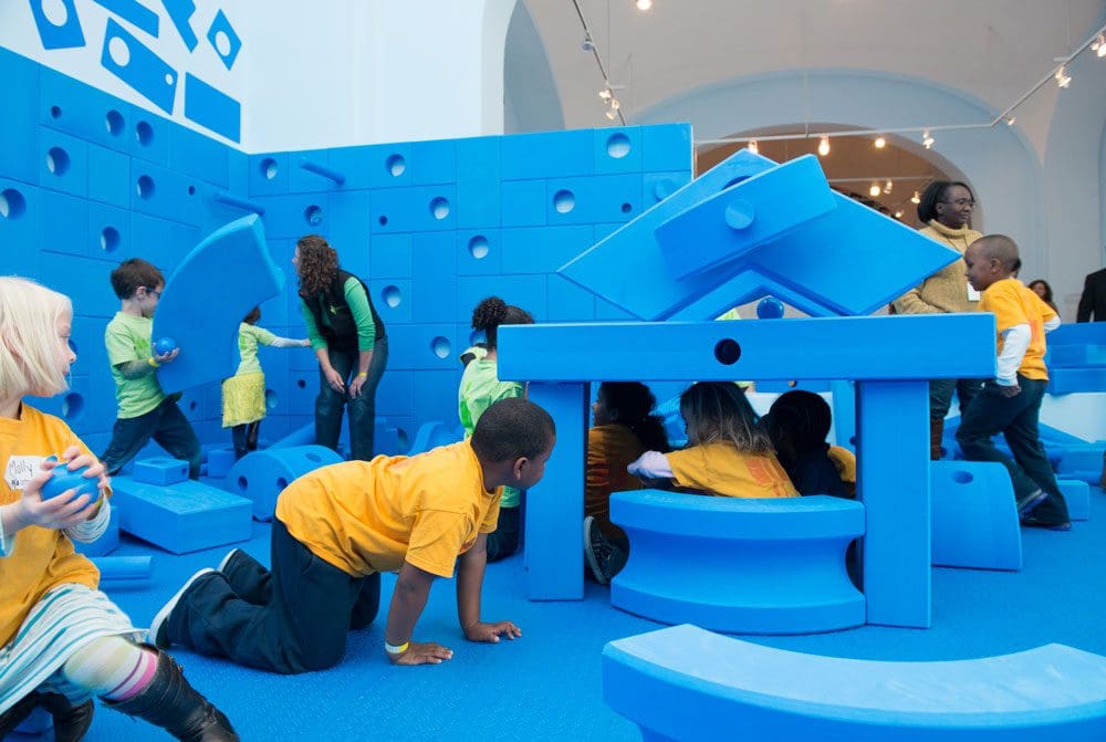 A class of kids crawls around an interactive exhibit at the National Building Museum, one of the stops on this DC itinerary for families with babies or toddlers.