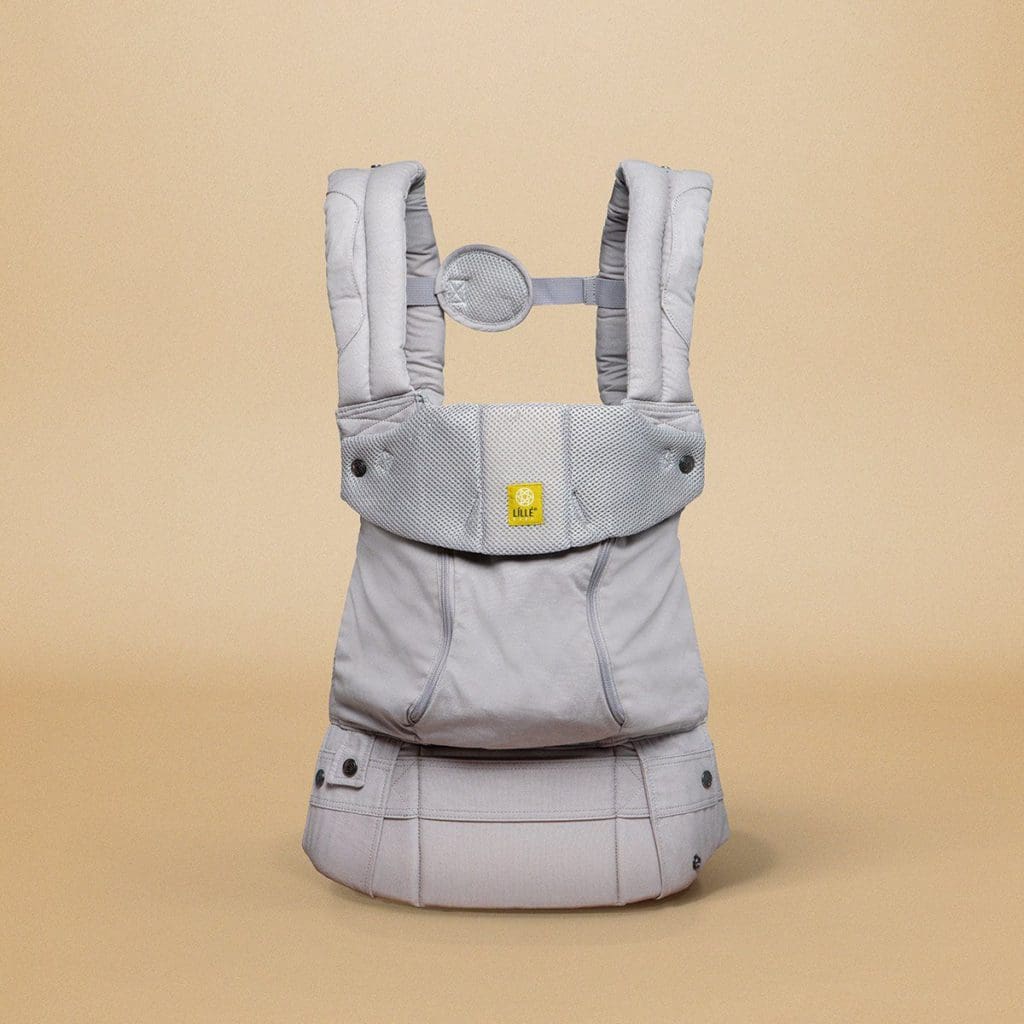 A product shot of a gray Lillebaby SeatMe All-Seasons Carrier, against a yellow background, one of the best Best baby carriers for travel.