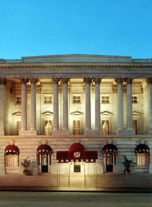 The entrance to the Kimpton Hotel Monaco Washington DC lit up at night.