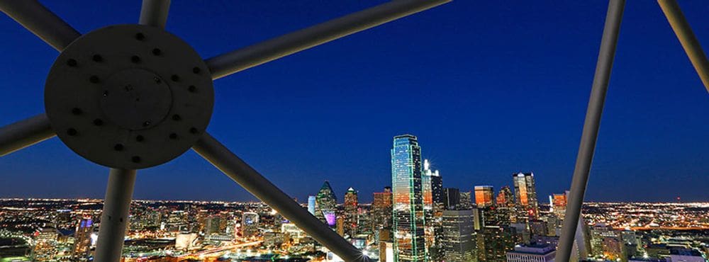 The skyline view at night from the Ge-O Deck at Reunion Tower, one of the best places to visit on a Dallas itinerary for families!