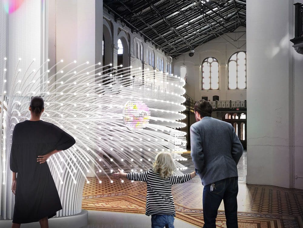 Two parents and their young child look upon a lit up exhibit at the Smithsonian National Museum of Natural History.