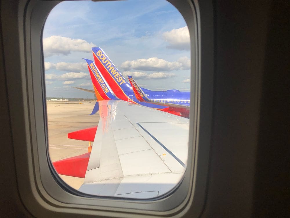 Through an plan window, the Southwest wings in red, blue, and yellow, are shown.