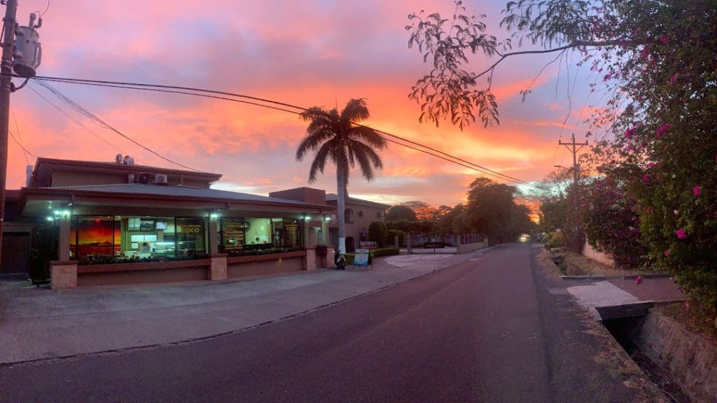 A look down Coco Viquez during a stunning sunset, featuring hues of purple, orange, and yellow.