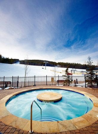 The hot tub at Crystal Peak Lodge, with a view of the slopes in the background.