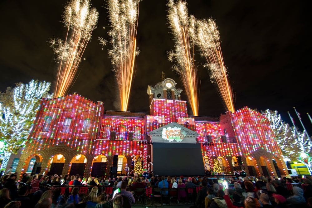 A large Christmas display at Grapevine, Texas, featuring a large crowd and festive lights.