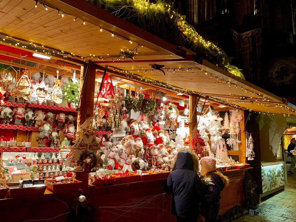 Two kids peek into a holiday stall in Europe.