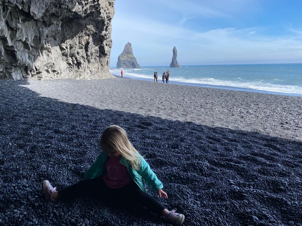 A young girl plays on Frazar Beach in Iceland.