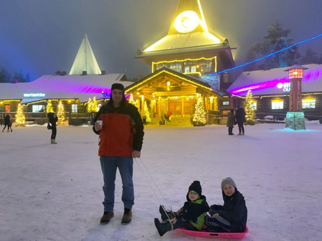 A dad pulls his two sons along on a sled in Findland.