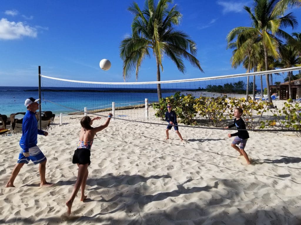 A dad and his three children play volley ball at the The Cove in the Bahamas.