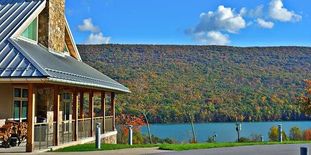 One of the cabins at The Nature Inn at Bald Eagle, featuring a porch and stunning view of the lake.