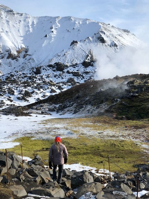 A young boy climbs up a trail through Landmannaluagar in Iceland.