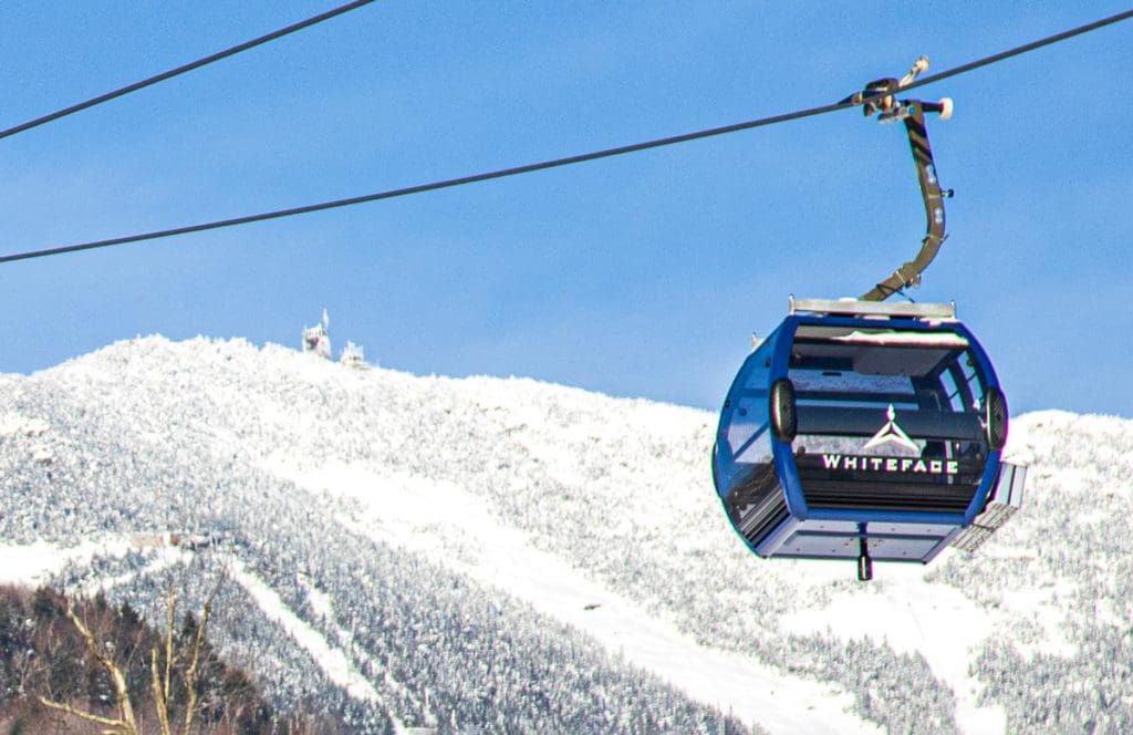 A view of the Cloudsplitter Gondola at Whiteface Mountain, moving across the cables on a snowy day.